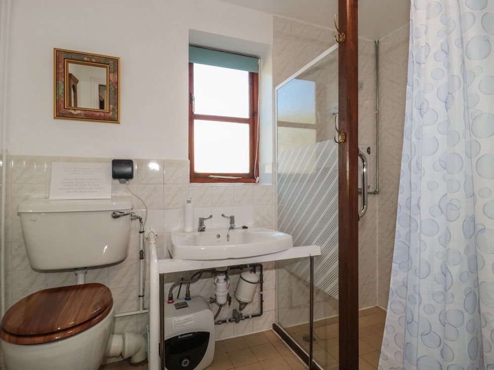 A bathroom with a sink, toilet, and shower at Walk Close Gloucester