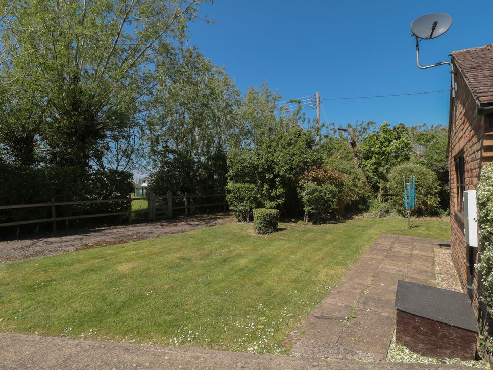 A garden with grass and bushes at Walk Close in Gloucester