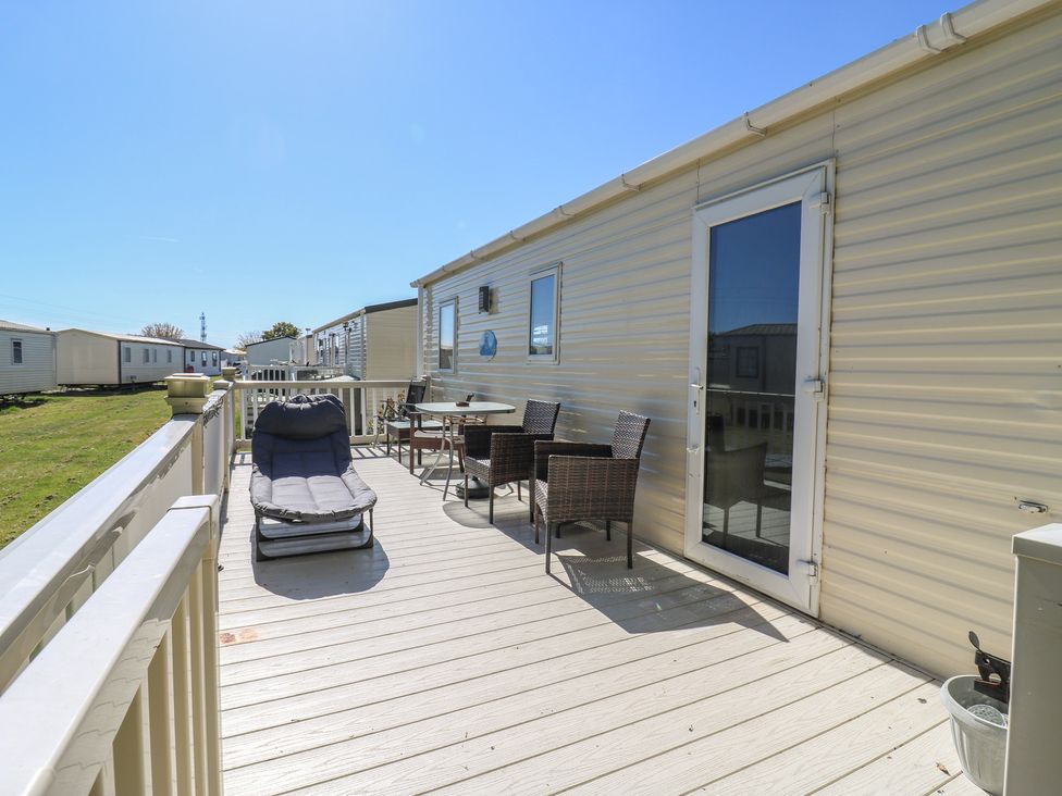A deck with chairs and a table at Valley Farm Number 448