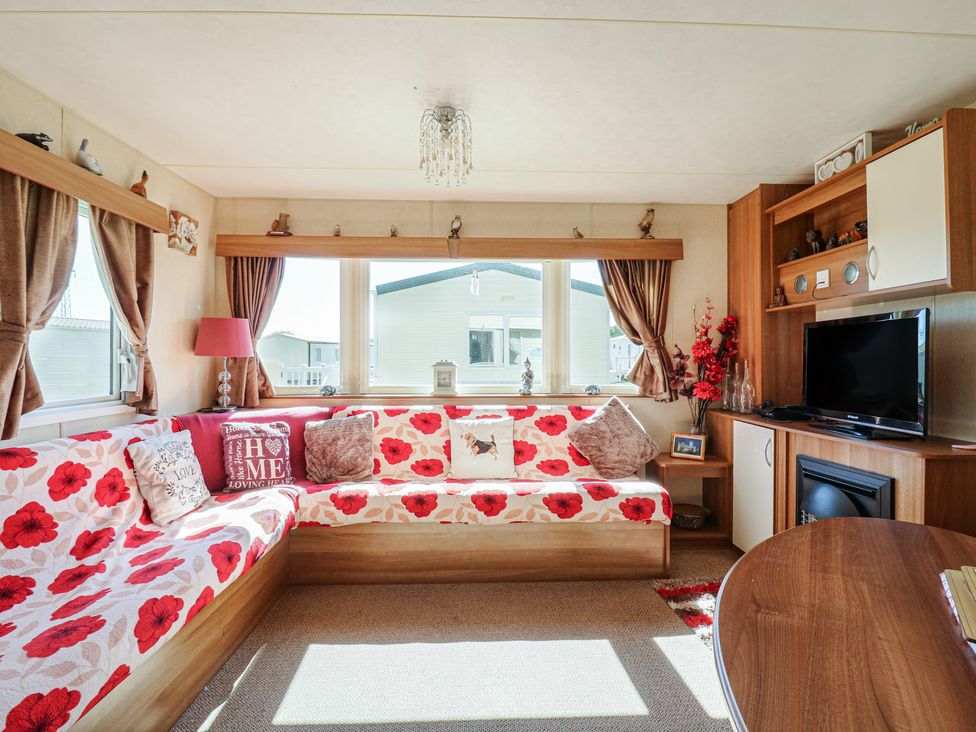 A living room with a sofa and television at Valley Farm Number 448