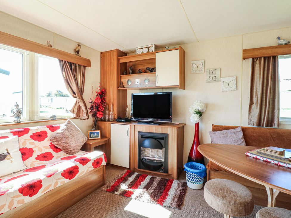 A living room with a sofa and television at Valley Farm Number 448