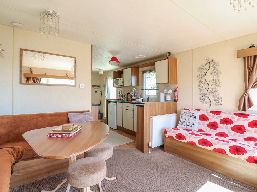 A living room with a table and sofa at Valley Farm Number 448