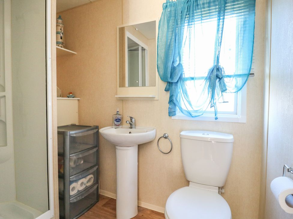 A bathroom with a shower, sink, and toilet at Valley Farm Number 448