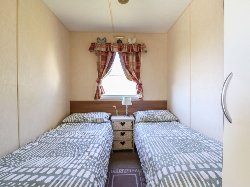 A bedroom with two beds and a nightstand at Valley Farm Number 448
