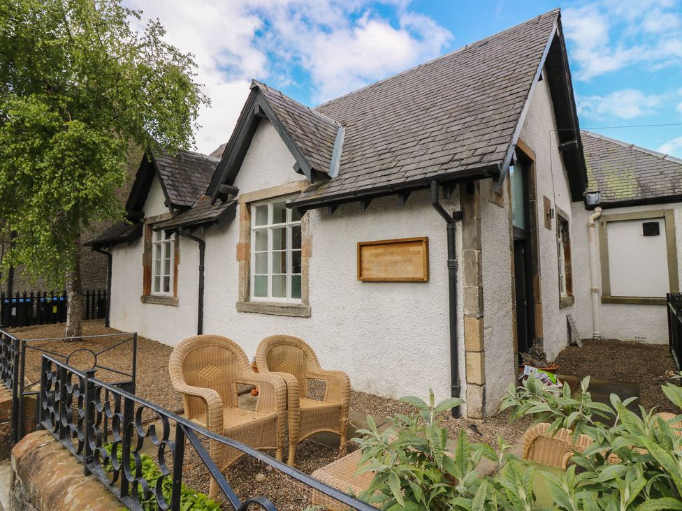 A house with two chairs and plants in front at The Old School Peebles