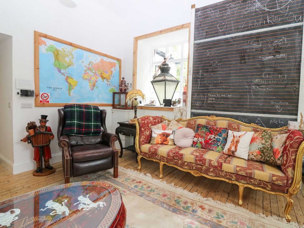 A living room with a map on the wall and a sofa at The Old School in Peebles