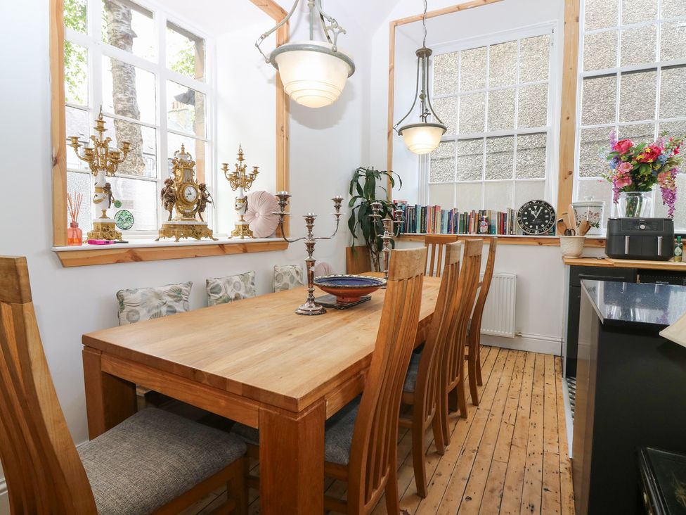 A dining room with a wooden table and chairs at The Old School in Peebles