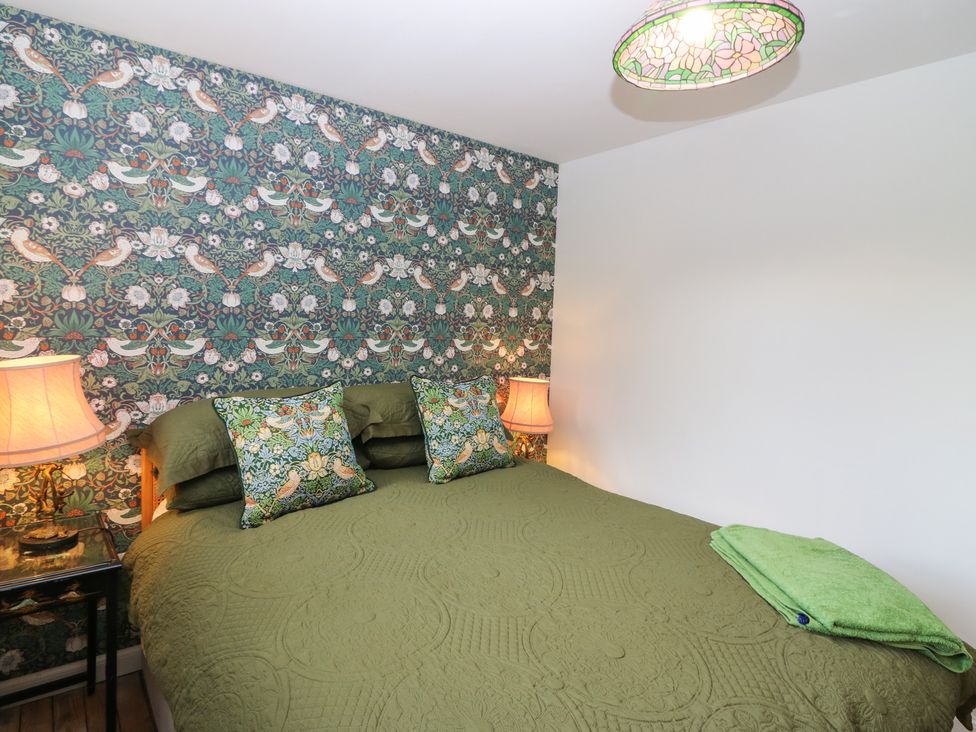 A bedroom with a bed and bedside table at The Old School in Peebles