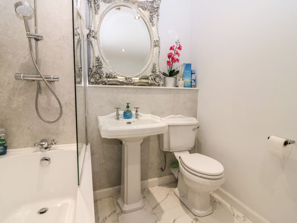 A bathroom with a shower, bathtub, sink, and toilet at The Old School in Peebles