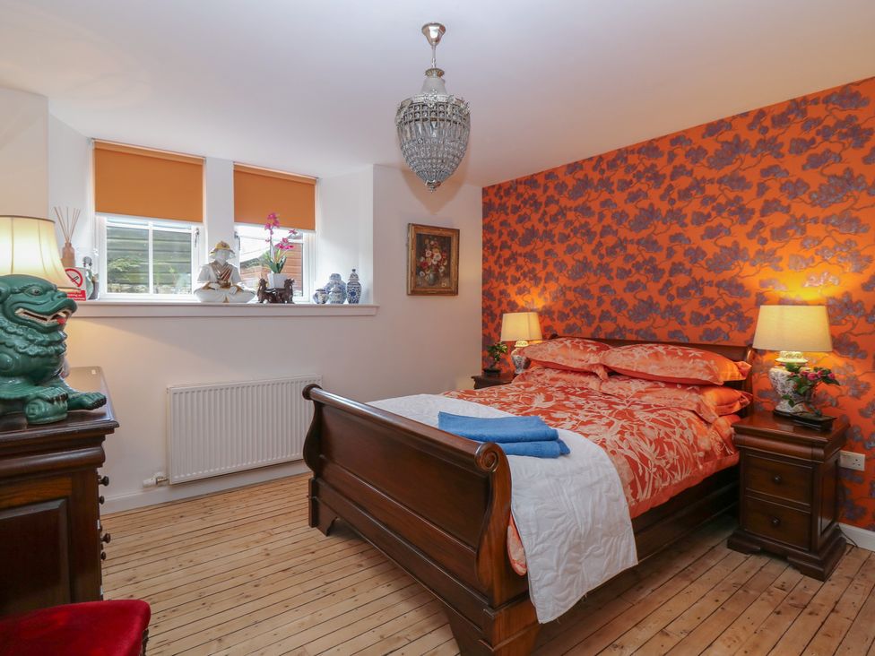 A bedroom with a bed and nightstands at The Old School in Peebles
