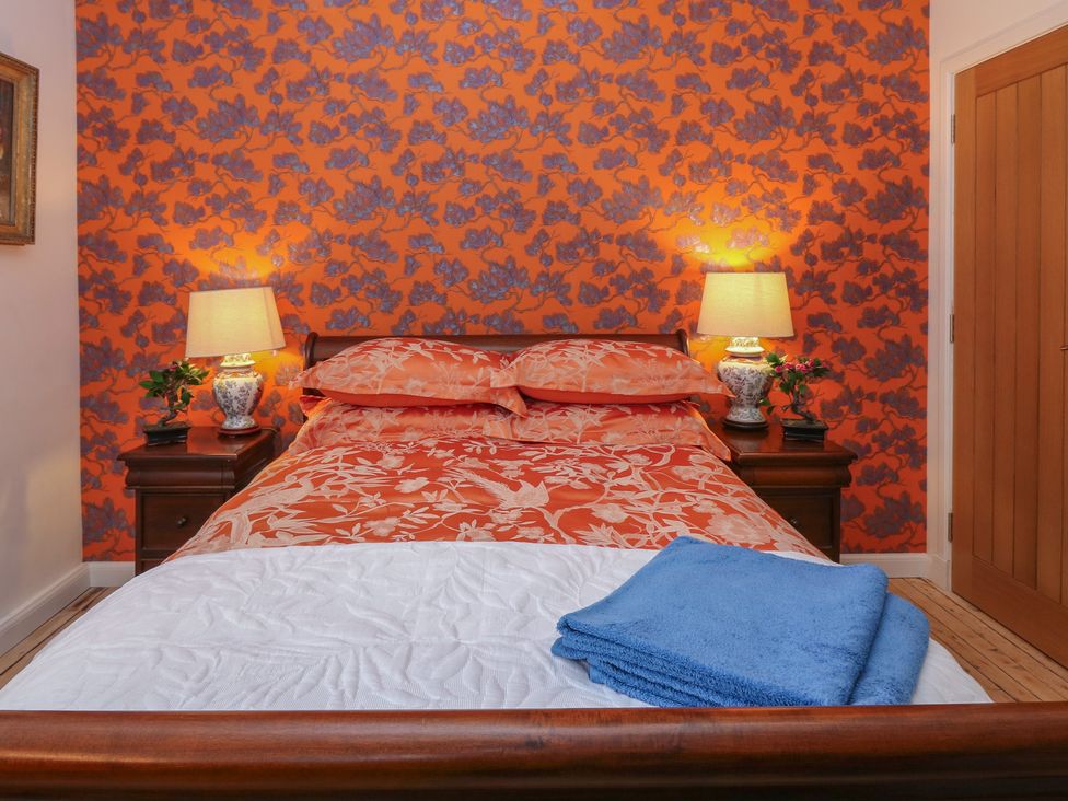 A bedroom with a bed and lamps at The Old School in Peebles