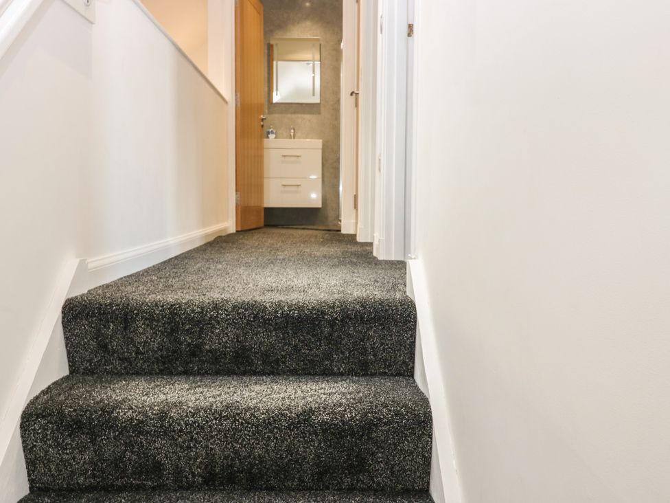A staircase leading to a hallway with a vanity unit at The Old School in Peebles