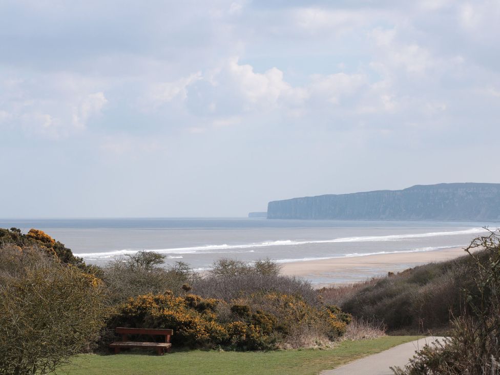 A view of the sea and cliffs with a bench in the foreground at 5 Station Avenue 
