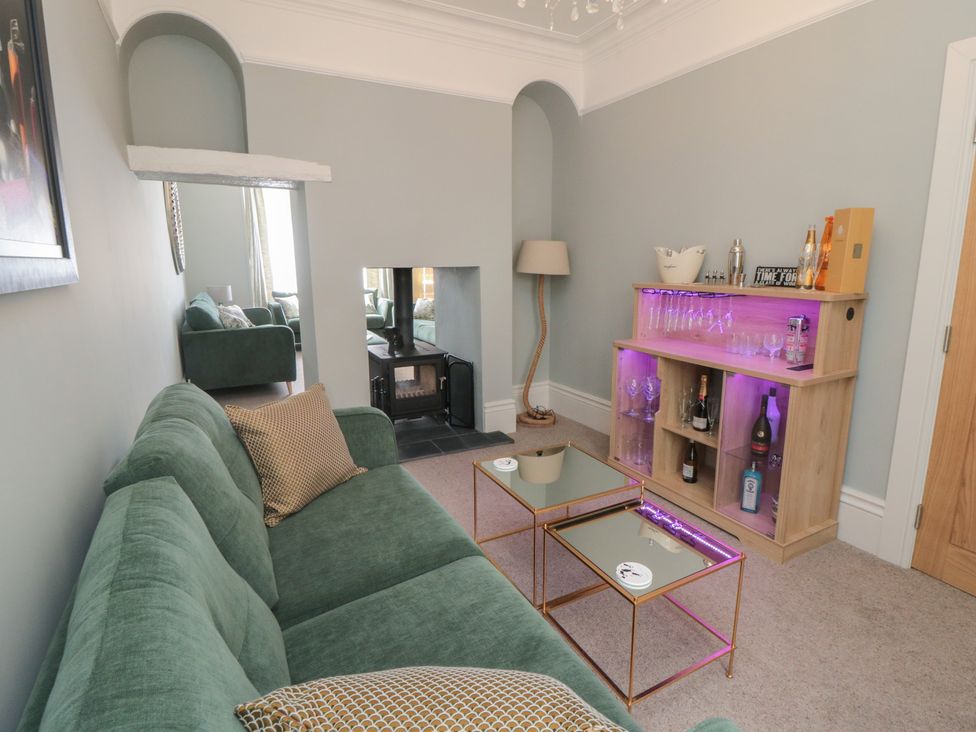 A living room with a sofa and bar unit at 5 Station Avenue