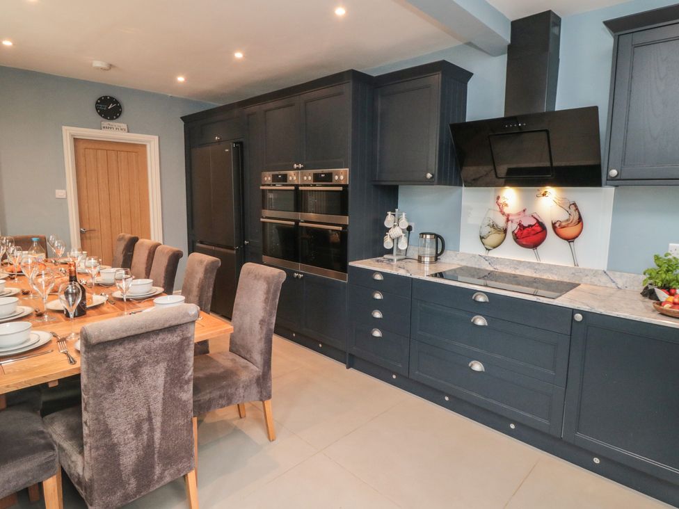 A kitchen with dining table and appliances at 5 Station Avenue 
