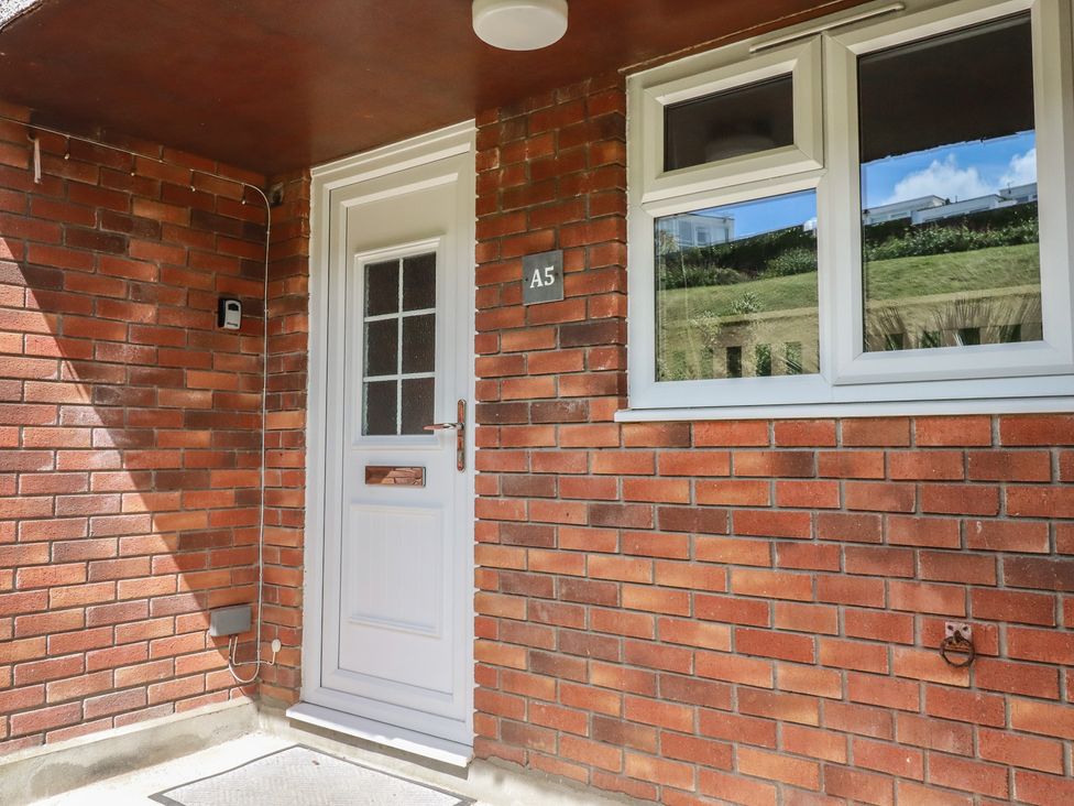 An entrance with a door and window at A5 Bay Apt.