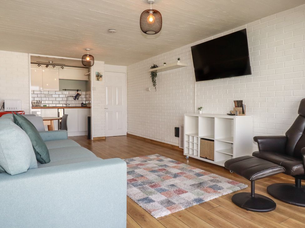 A living room with a sofa and television at A5 Bay Apt.