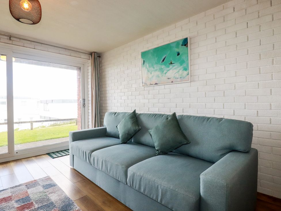 A living room with a sofa and window view at A5 Bay Apt.