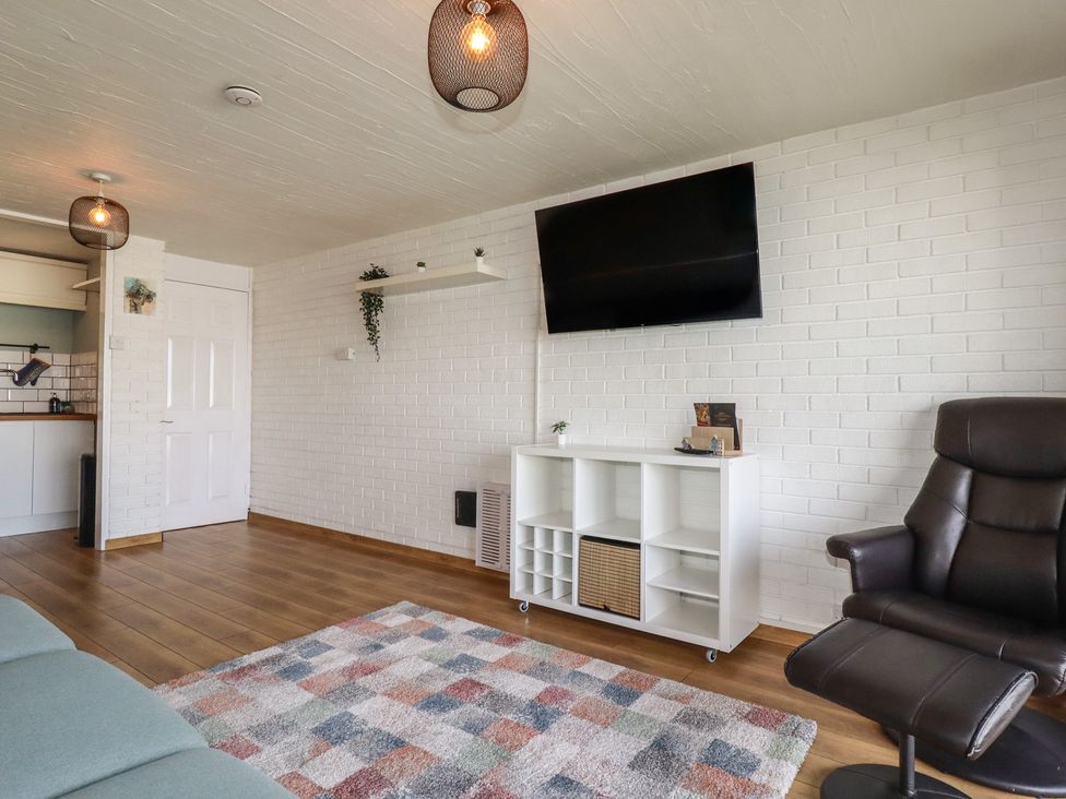 A living room with a sofa and television at A5 Bay Apt.