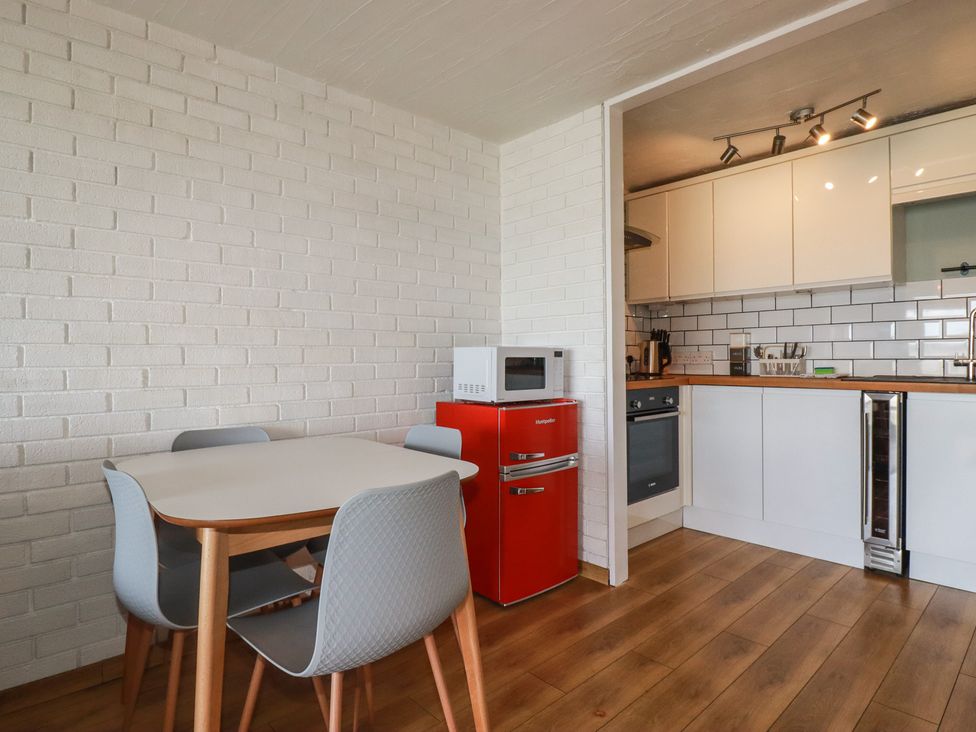 A kitchen with a table and chairs at A5 Bay Apt.
