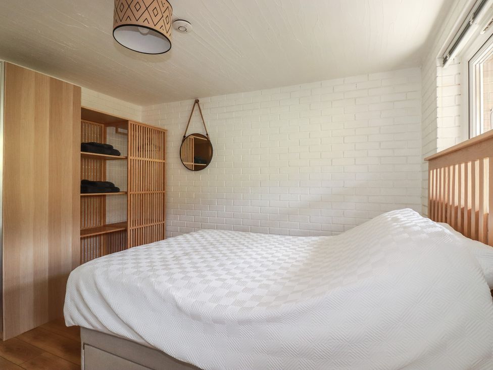 A bedroom with a bed and shelf at A5 Bay Apt.