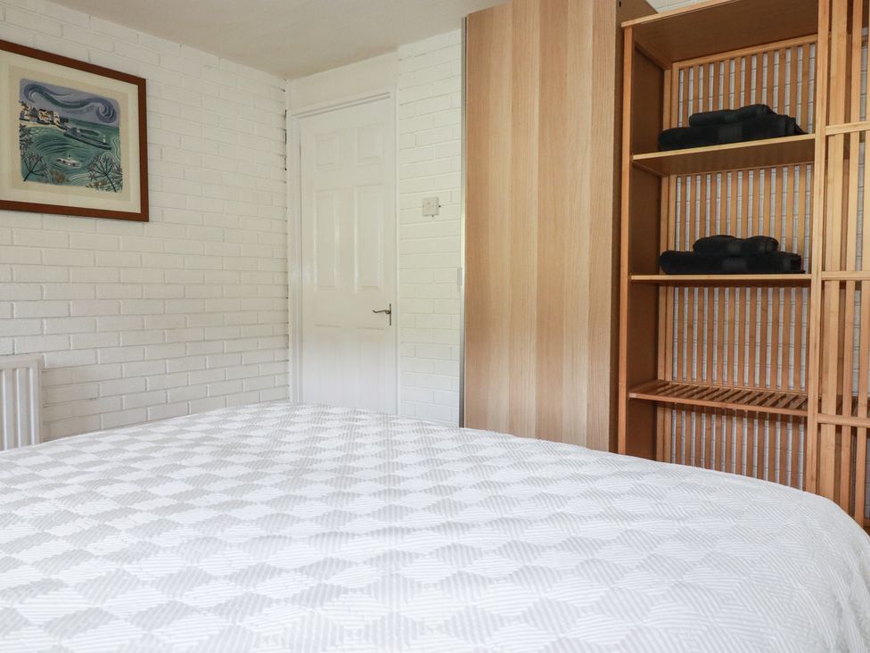 A bedroom with a bed, wardrobe, and shelf at A5 Bay Apt.