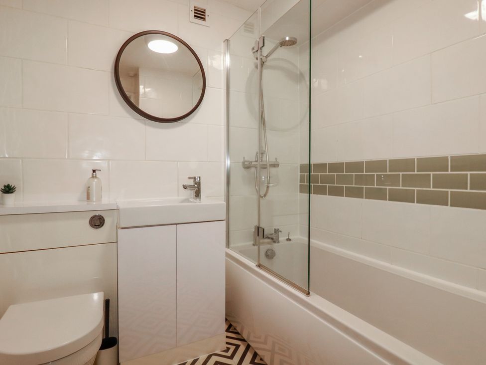 A bathroom with a bathtub, shower, sink, and toilet at A5 Bay Apt.