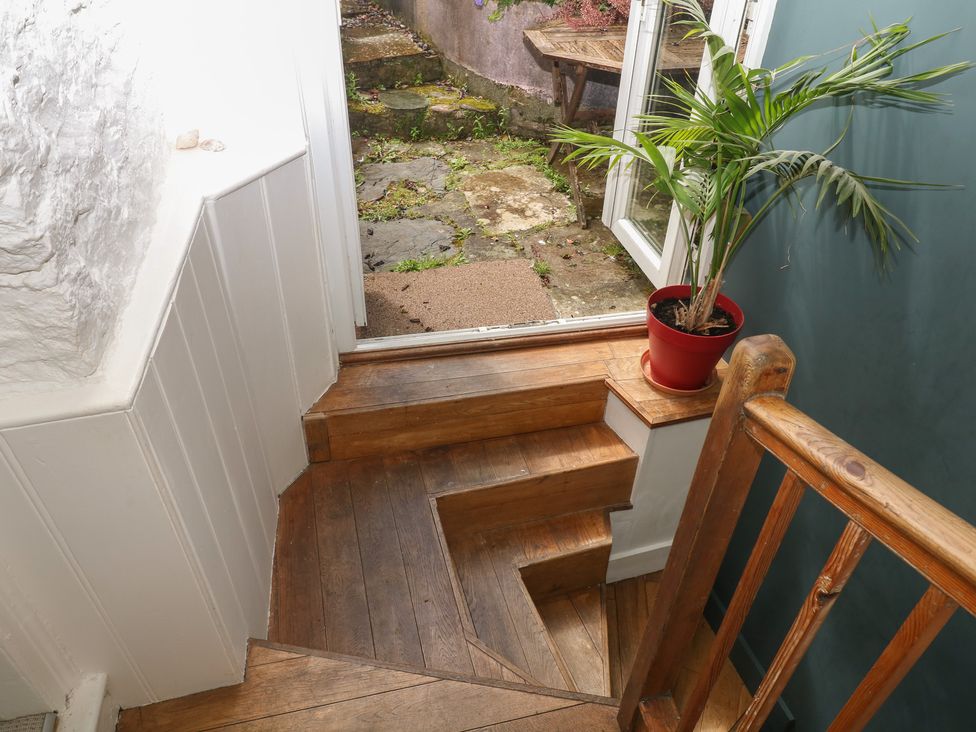 A staircase leading to a garden area at Tiller Cottage in Dartmouth