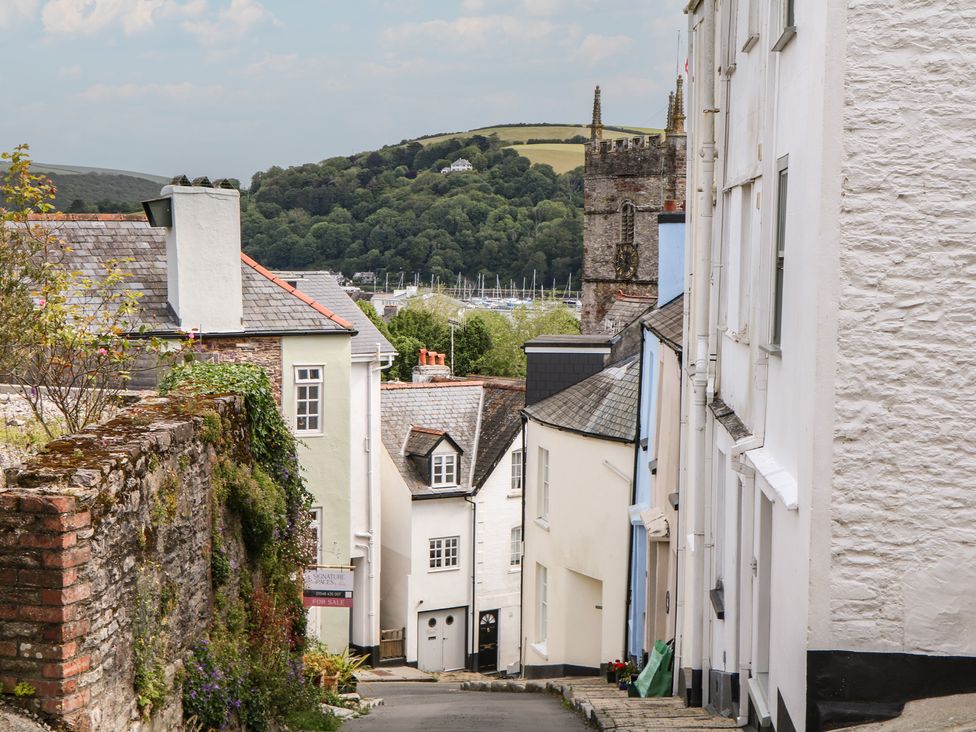 A street view featuring houses and a church in Dartmouth