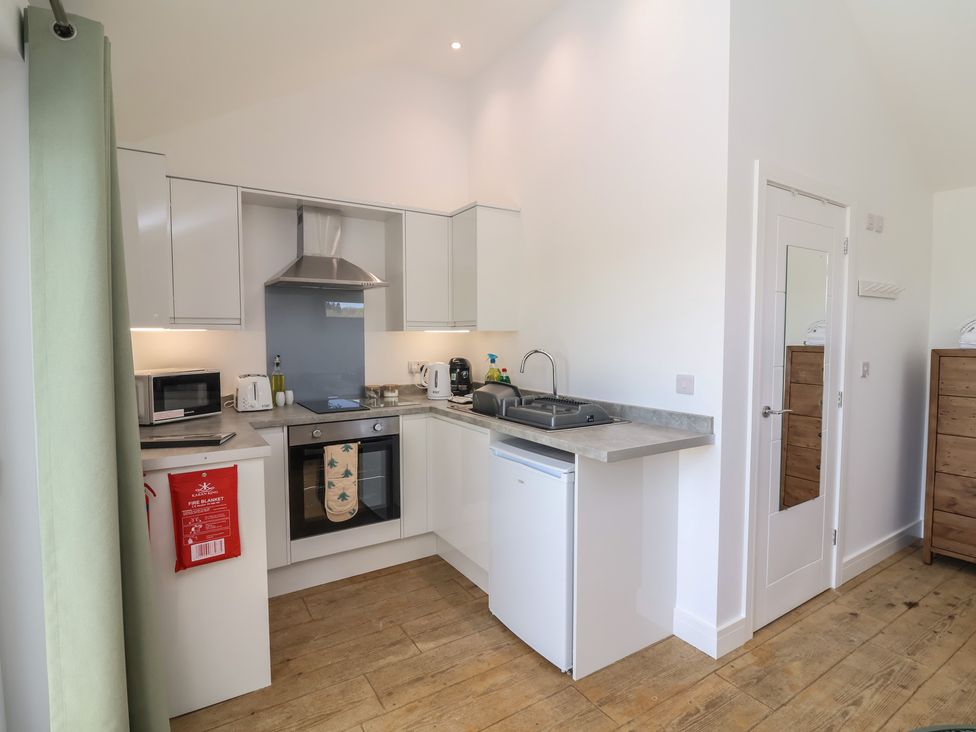 A kitchen with appliances and a sink at Willow in Barnstaple