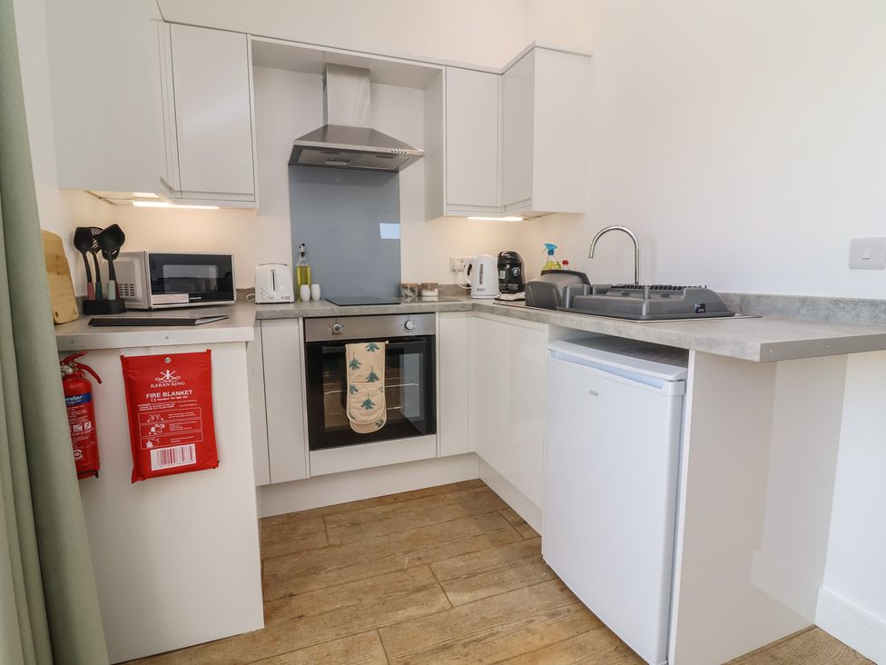 A kitchen with a microwave, kettle, and oven at Willow in Barnstaple