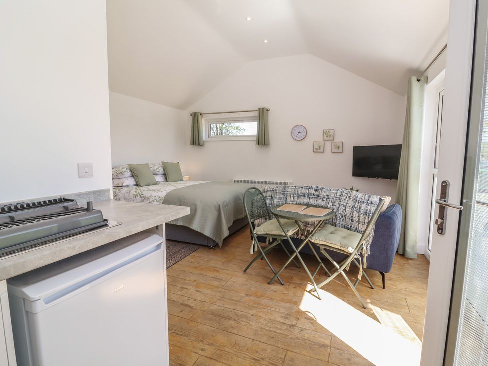 A studio with a bed and seating area at Willow in Barnstaple