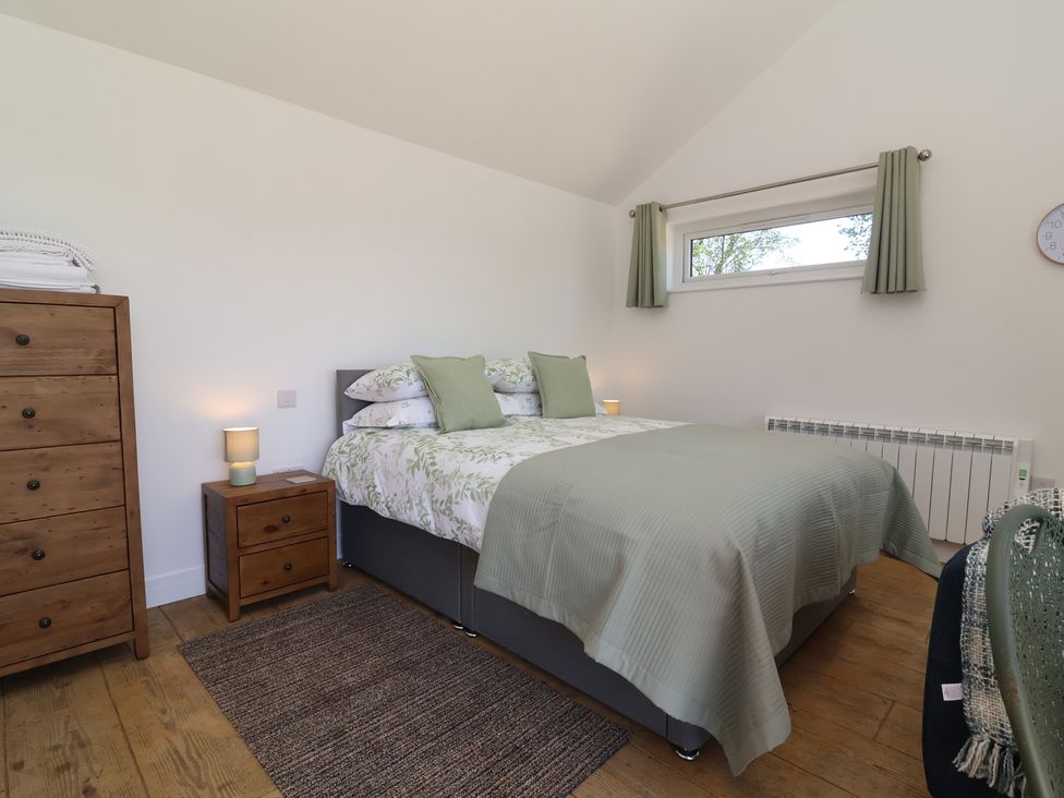 A bedroom with a bed and bedside table at Willow in Barnstaple