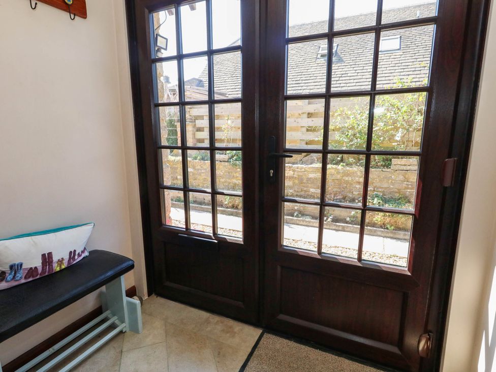 A hallway with double doors and a bench at Dunvant in Swanage