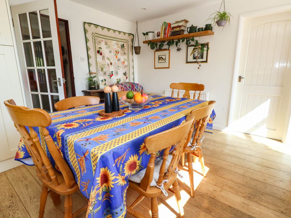 A dining room with a table and chairs at Dunvant Swanage