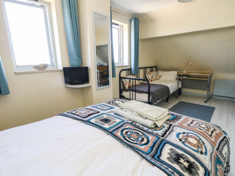 A bedroom with a double bed and a single bed at Dunvant in Swanage