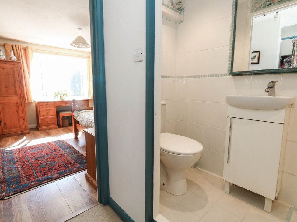 A bathroom with a toilet and sink at Dunvant in Swanage