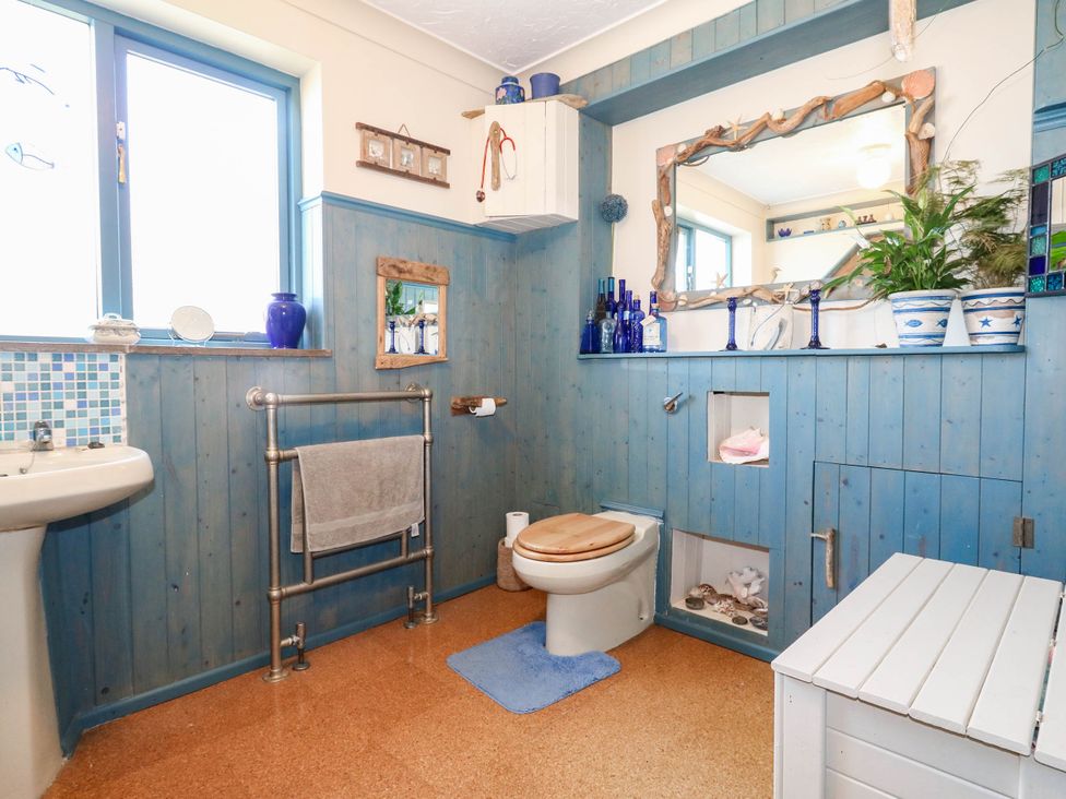A bathroom with a sink and toilet at Dunvant in Swanage