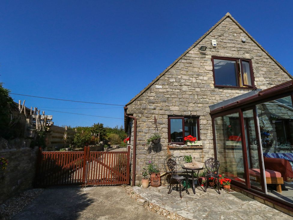 A building with a gate and seating area at Dunvant in Swanage