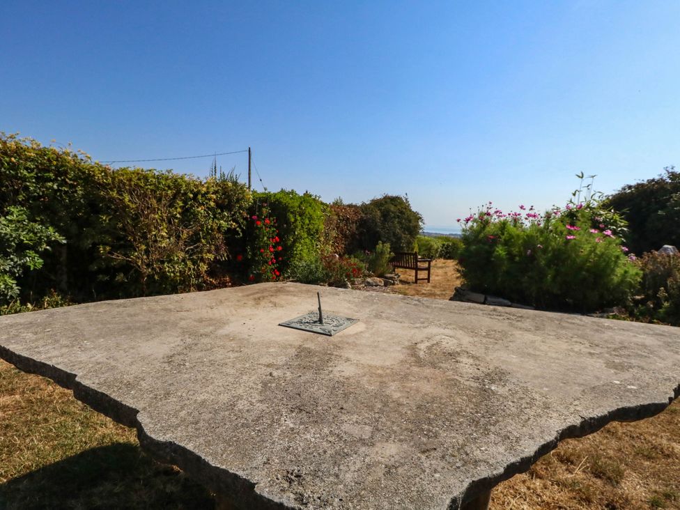 A garden with a sundial on a concrete table at Dunvant in Swanage
