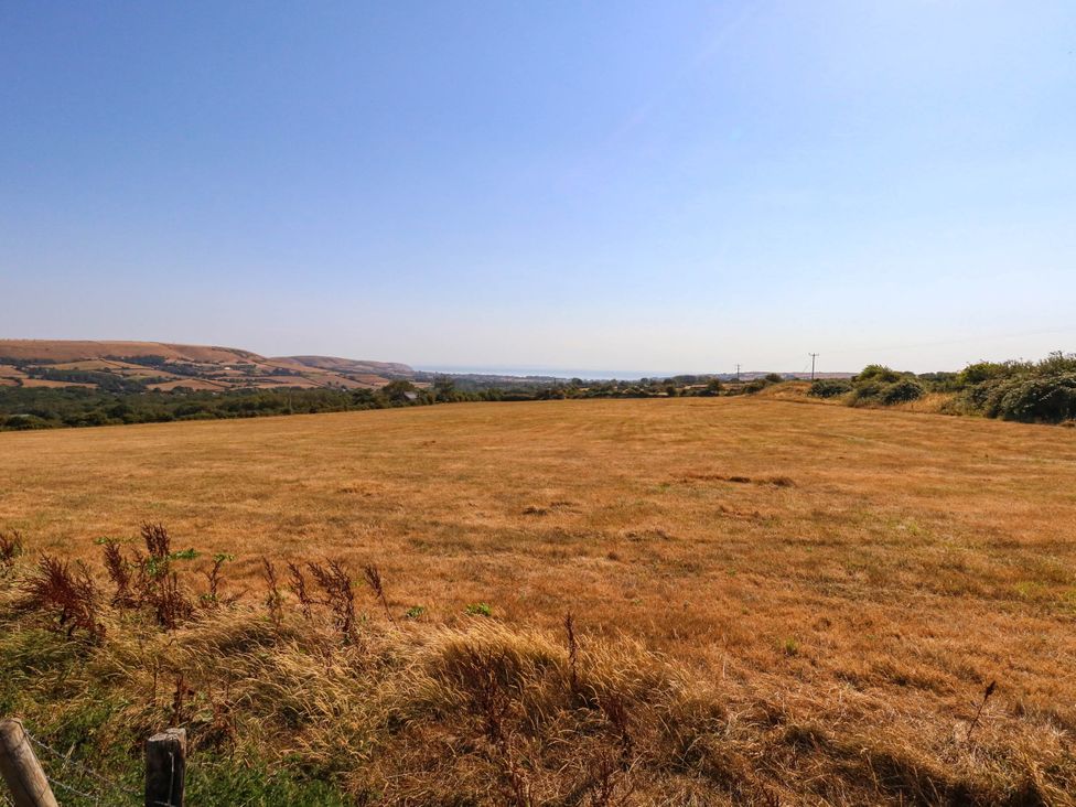 A field with hills and a clear sky at Dunvant, Swanage