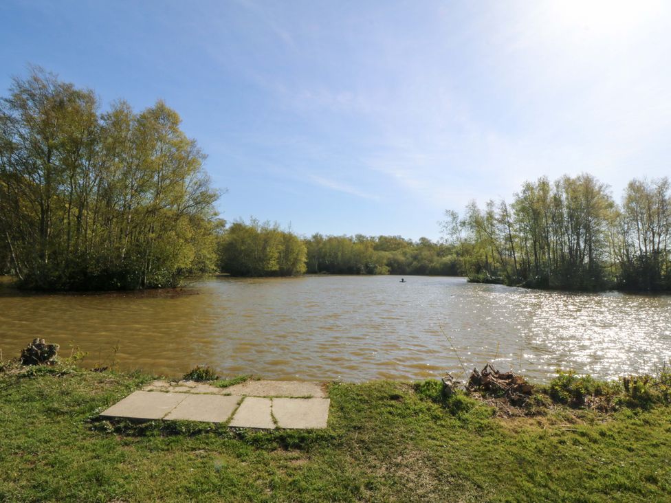 A lake with trees and a path by the water at Lodge 6 - Sleep 4 - Twin and Double in Criccieth