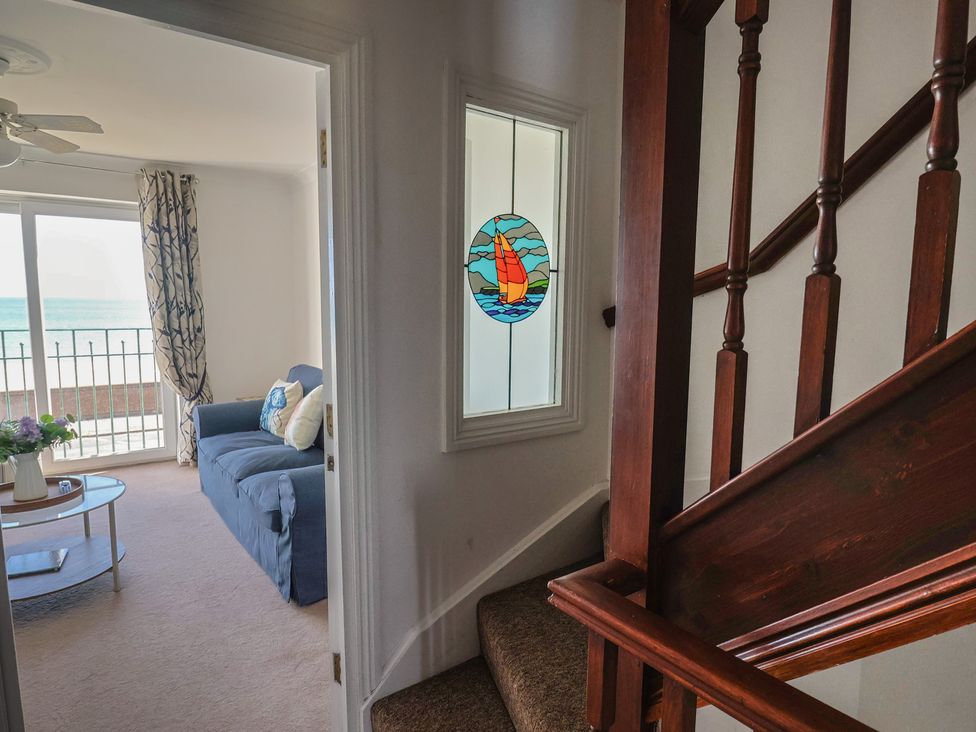 A living room with a couch and coffee table at 2 Lyme Mews Seaton