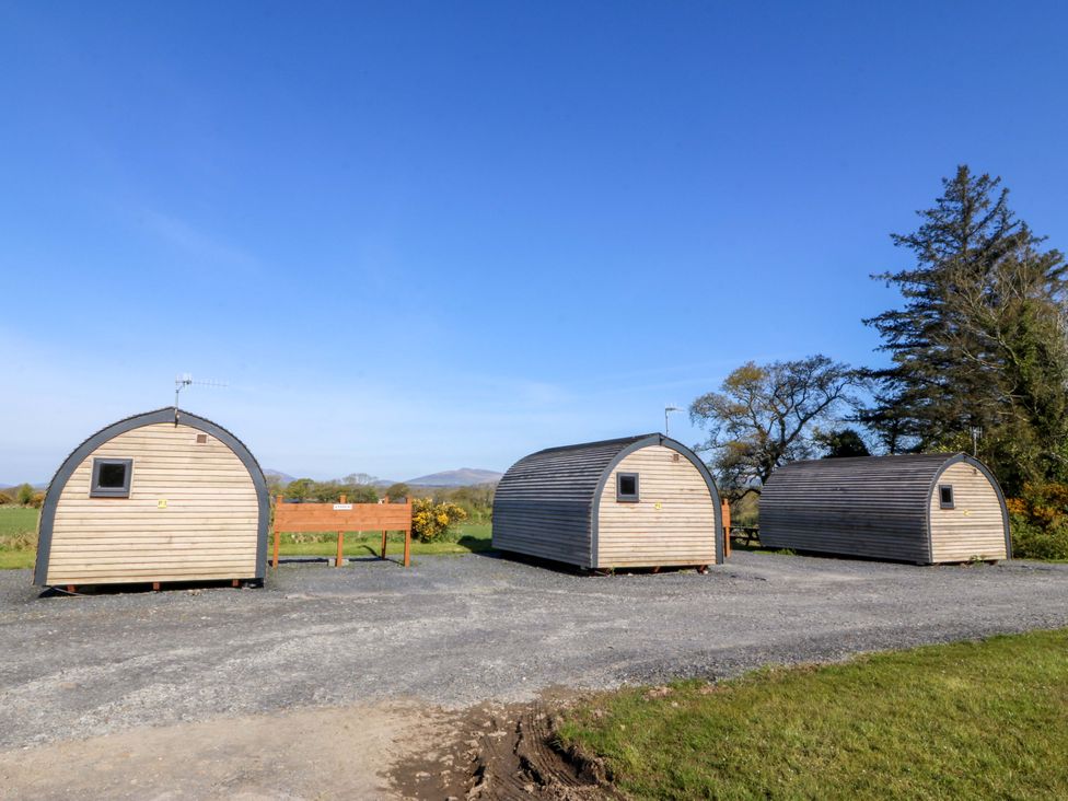 Wooden cabins in a field at Bron Eifion Pod 2 Criccieth