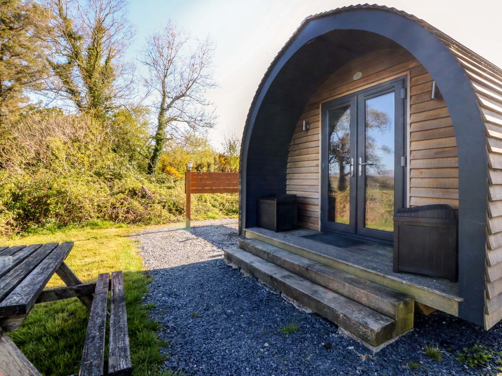 An outdoor view of a pod with steps and surrounding greenery at Bron Eifion Pod 2 Criccieth