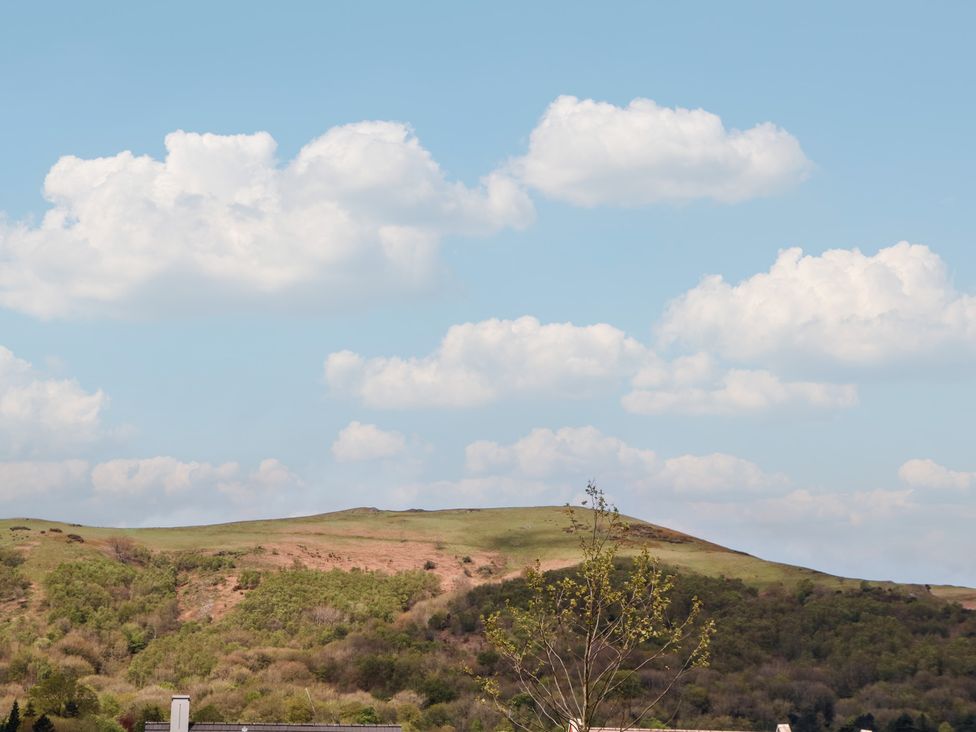 A view of hills and clouds in the sky at 56 Strothers Avenue