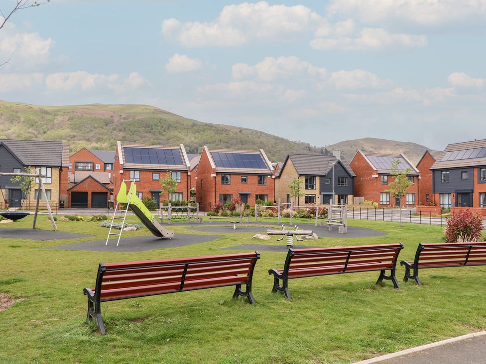 An outdoor playground with houses in the background at 56 Strothers Avenue