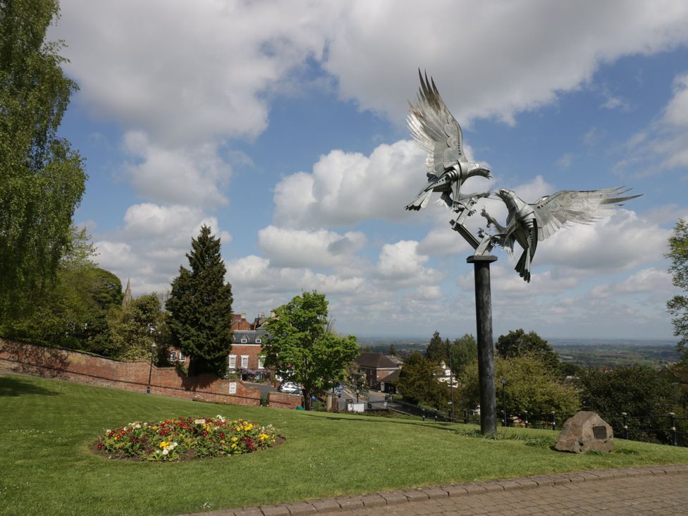 A sculpture of two birds in a park area at 56 Strothers Avenue