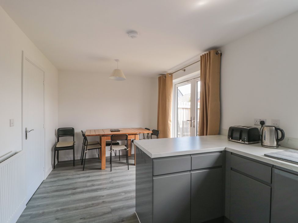 A kitchen with a dining table and chairs at 56 Strothers Avenue, Malvern