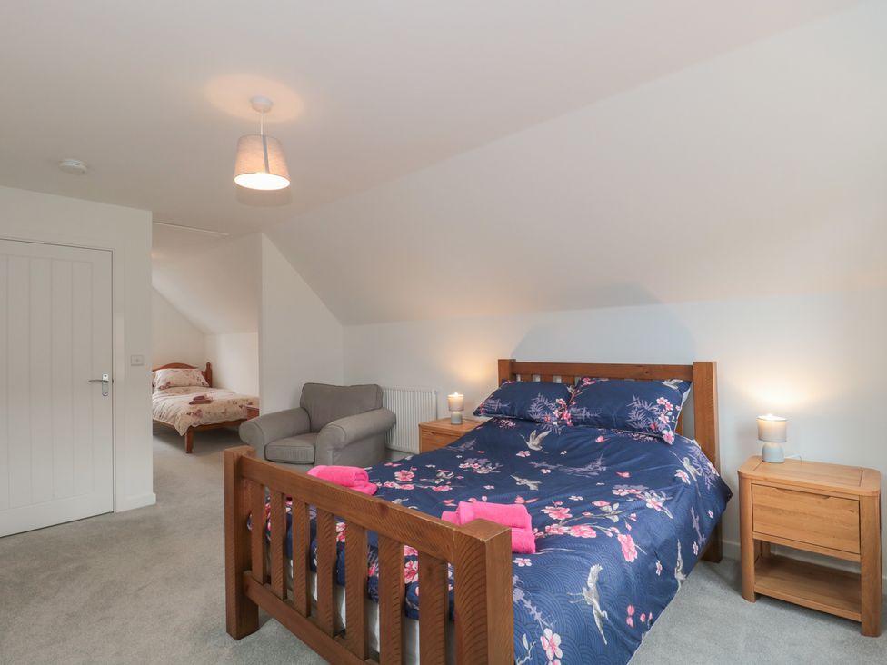 A bedroom with a bed and sofa at 56 Strothers Avenue in Malvern